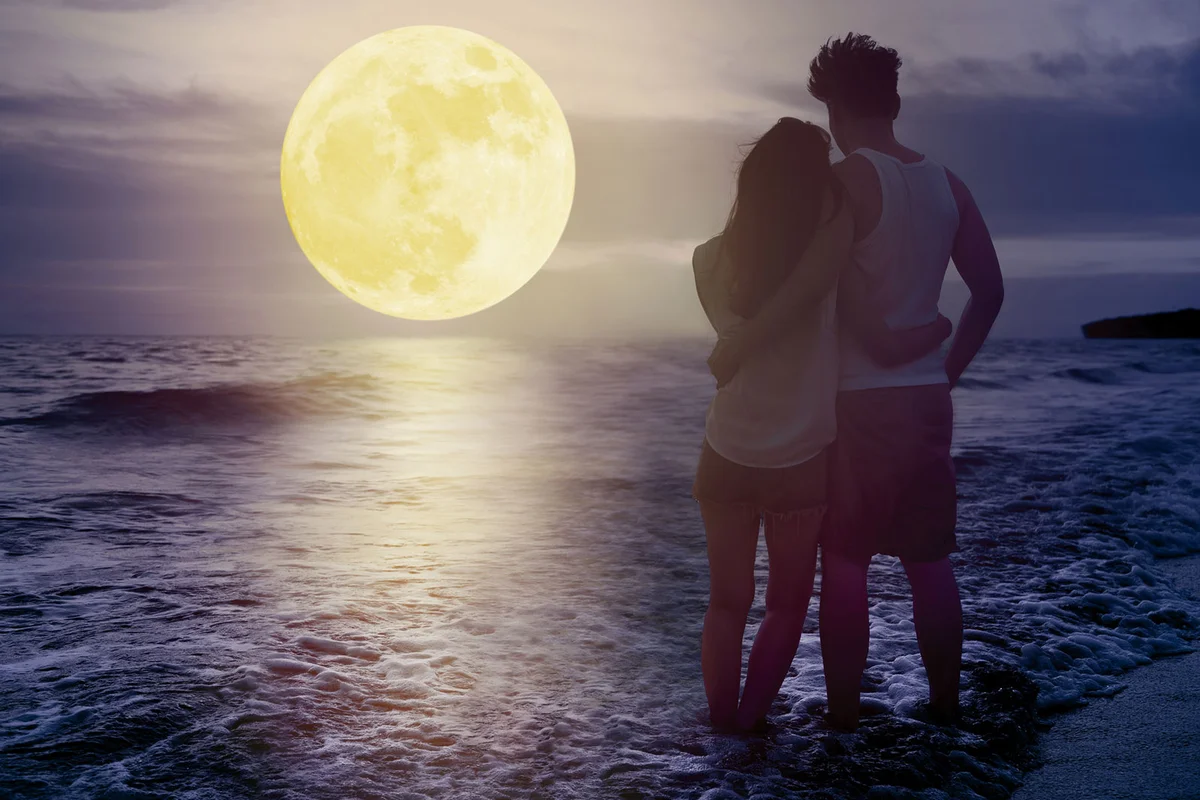 couple at beach under full moon