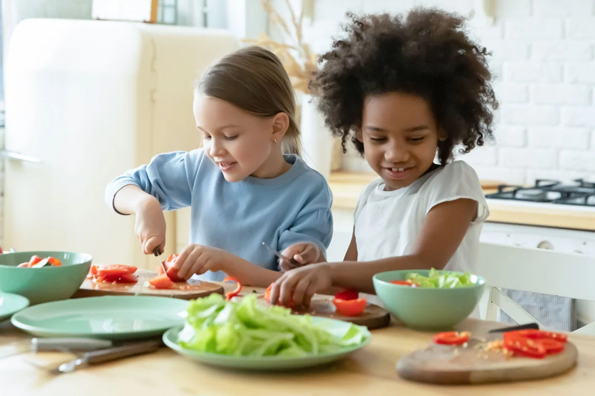 friends at a cooking birthday party making salad