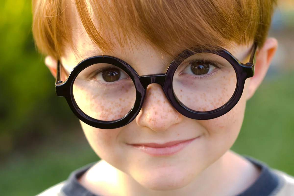 boy in round glasses at Harry Potter theme birthday party