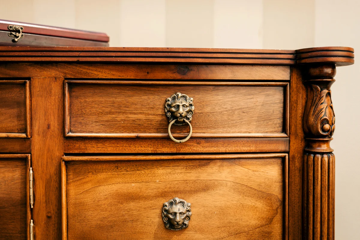 Vintage cabinet with drawers and doors with simple wooden carvings
