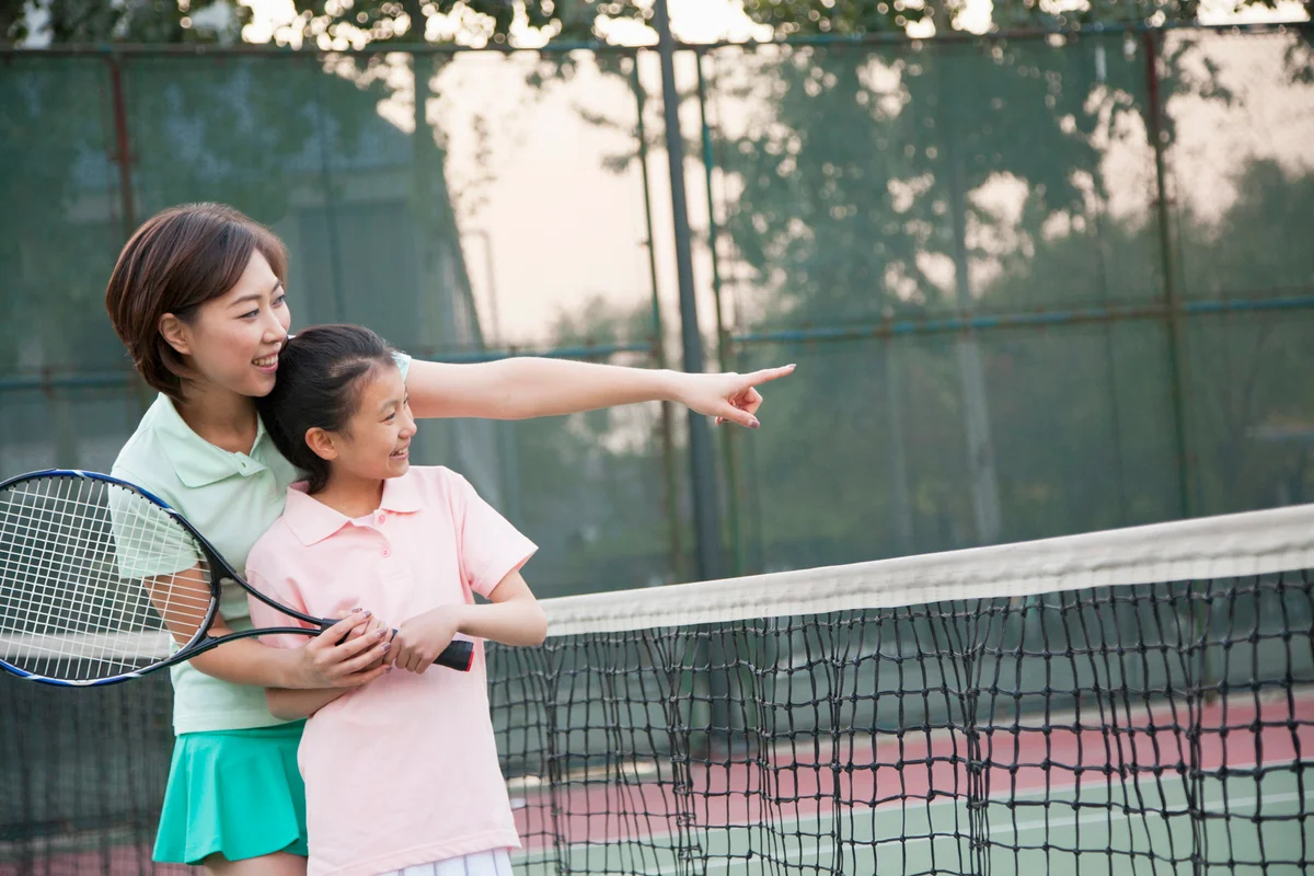 Mother and daughter playing tennis