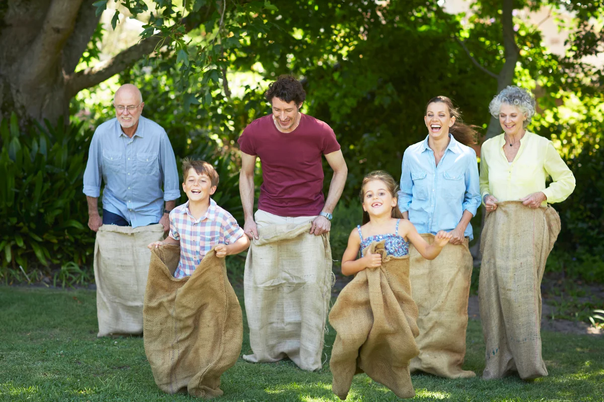 Family having sack race in park