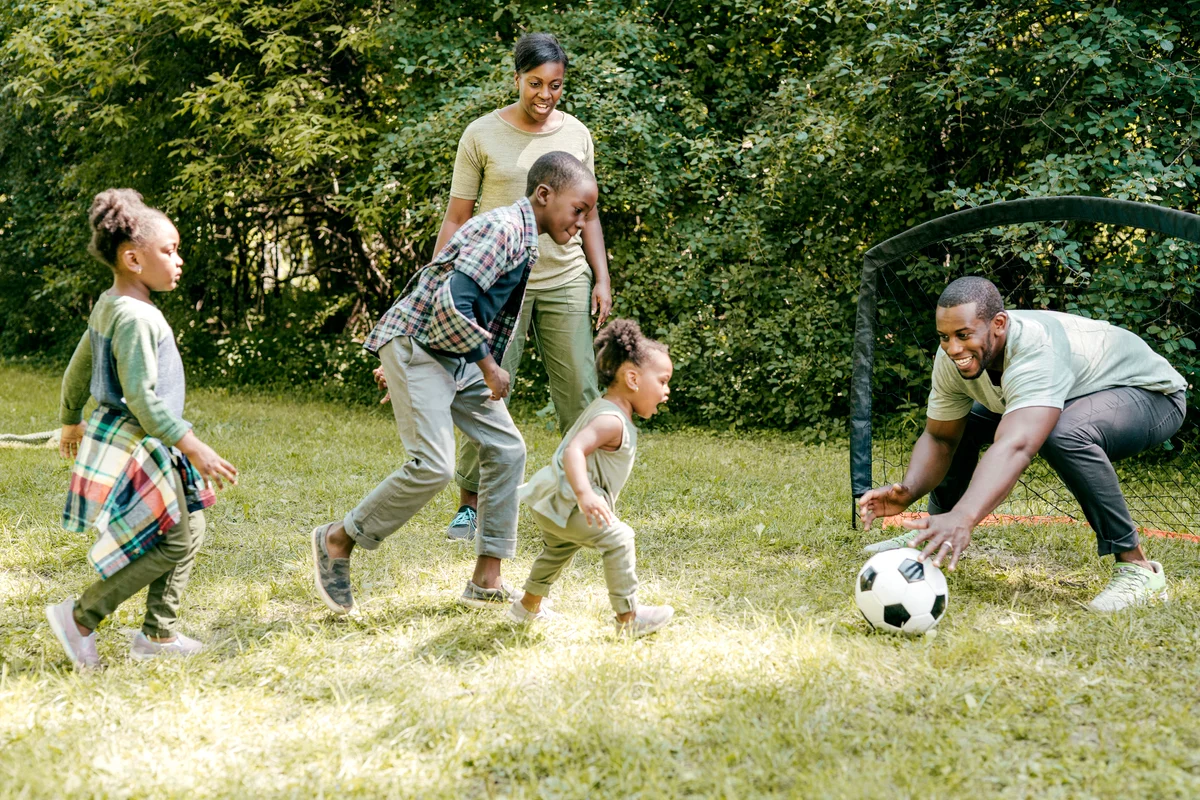 Family playing soccer