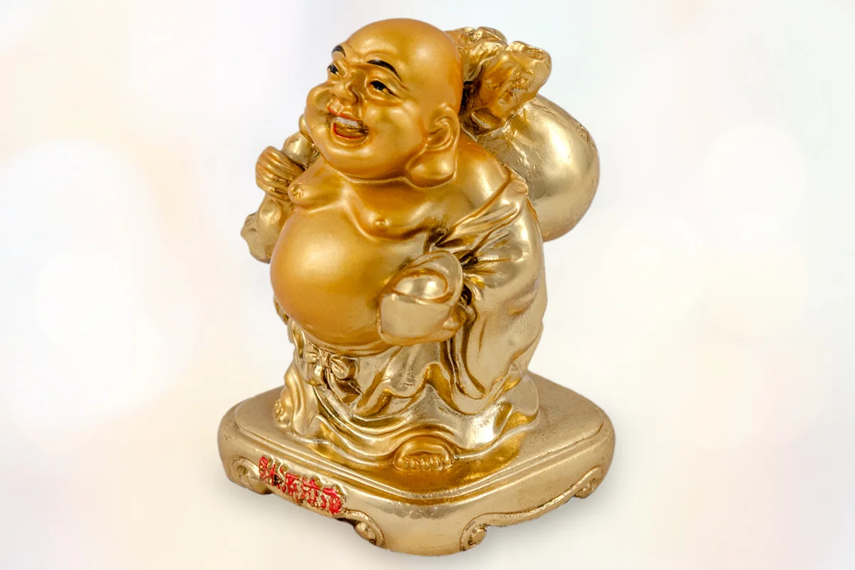 small golden figurine of buddha