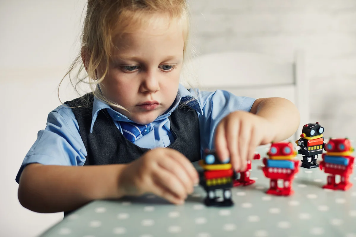 Child playing with toy robots
