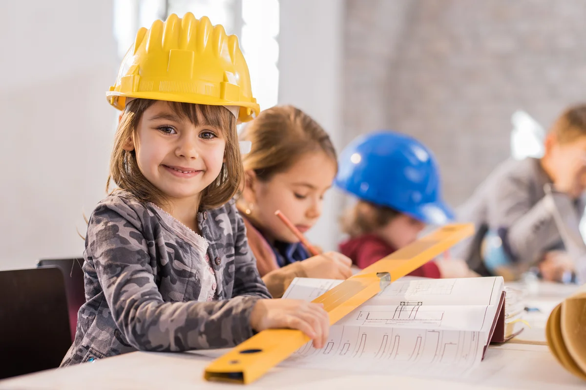 Little girl architect smiling and looking at camera