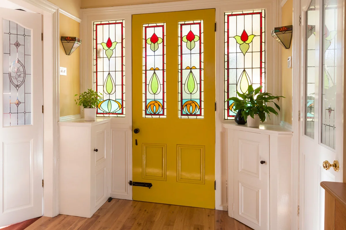 front entry of home with beautiful leaded stained glass windows