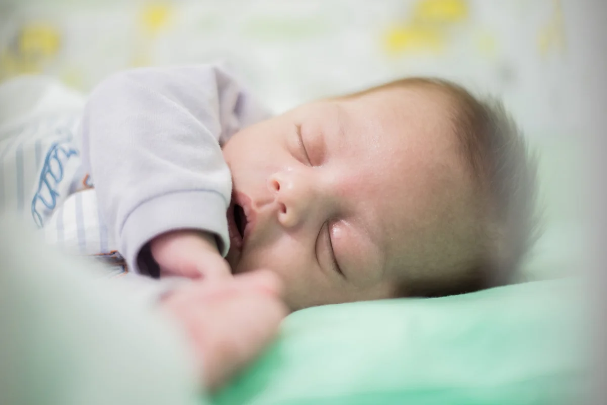 Cute Baby Boy Sleeping On Crib