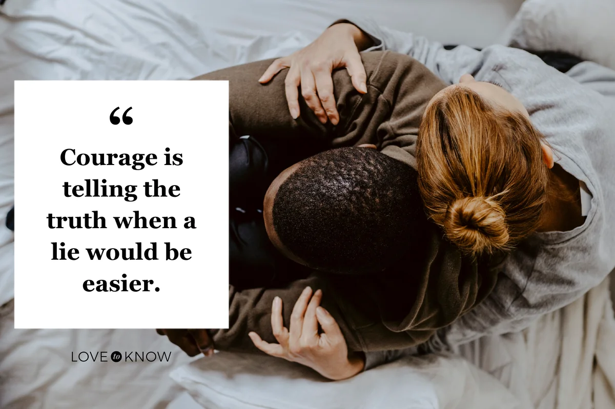 Mother embracing son on bed at home