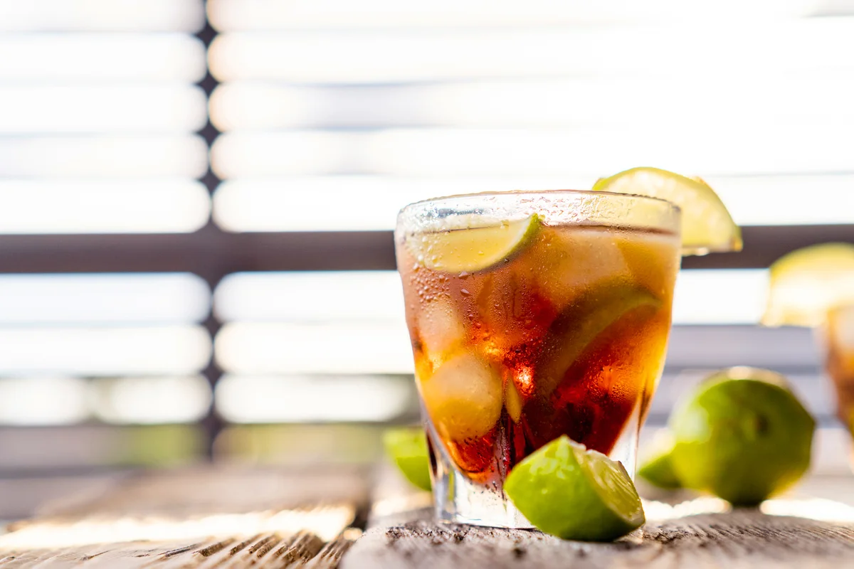 Cuba Libre cocktail with brown rum and lime