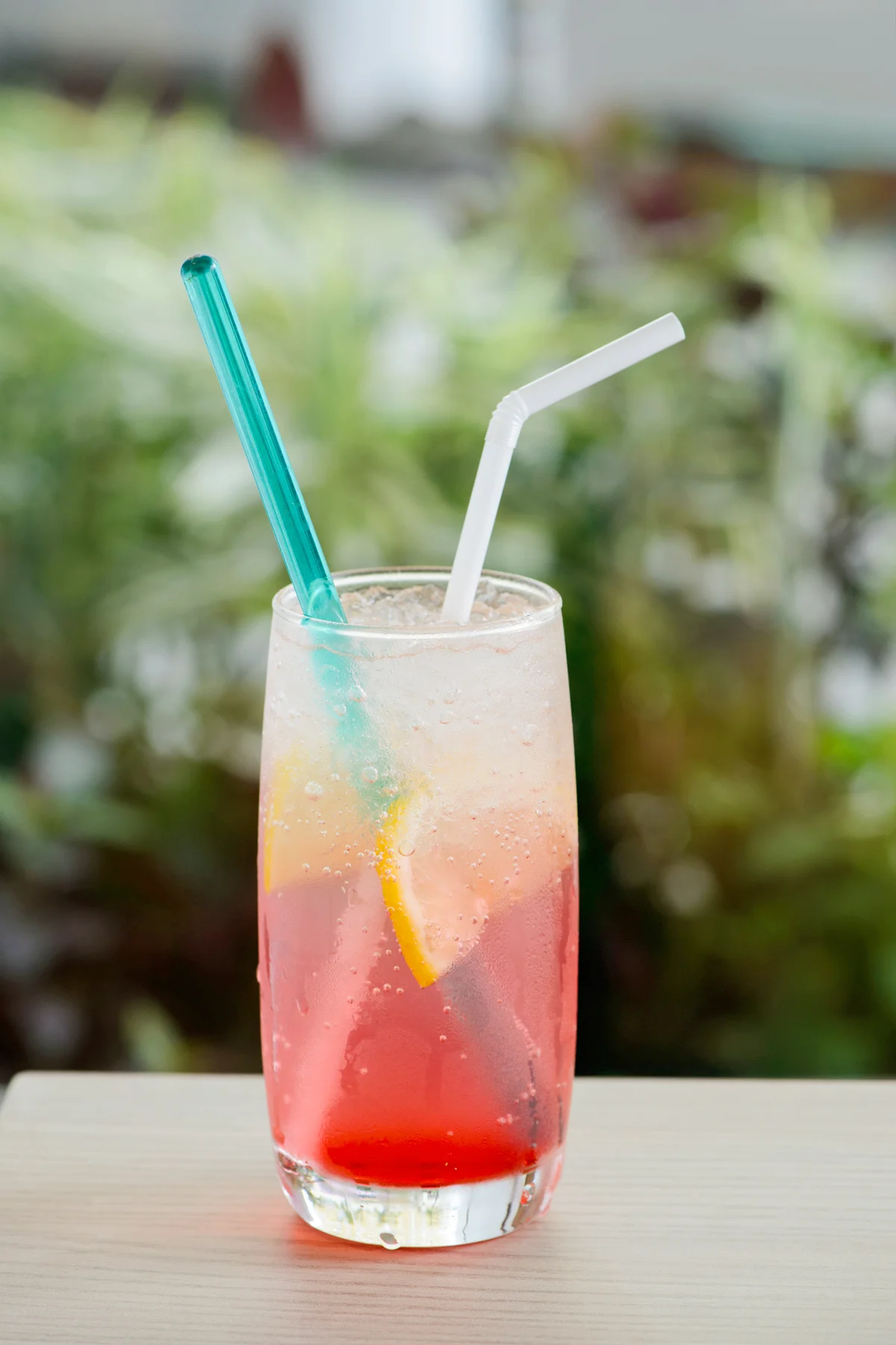 Pink drink with lemon garnish