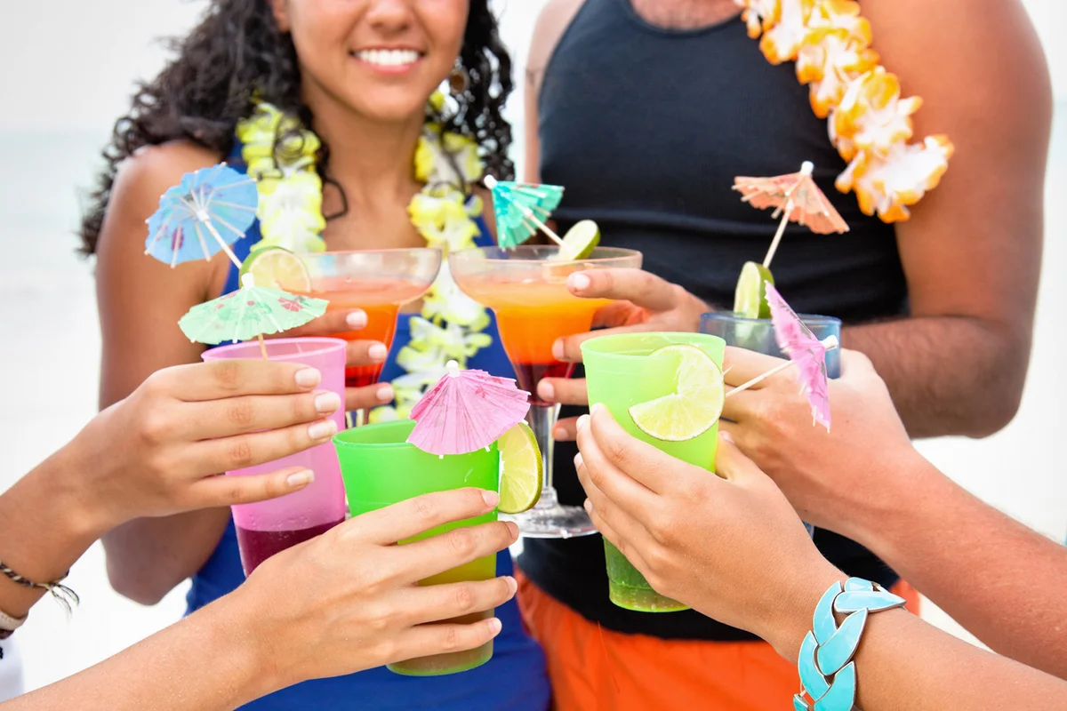 Friends toasting with tropical drinks