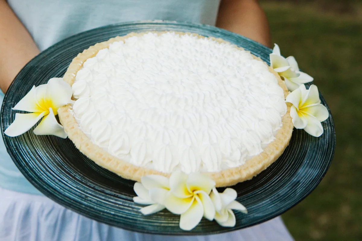 Woman holding haupia Hawaiian coconut cream pie