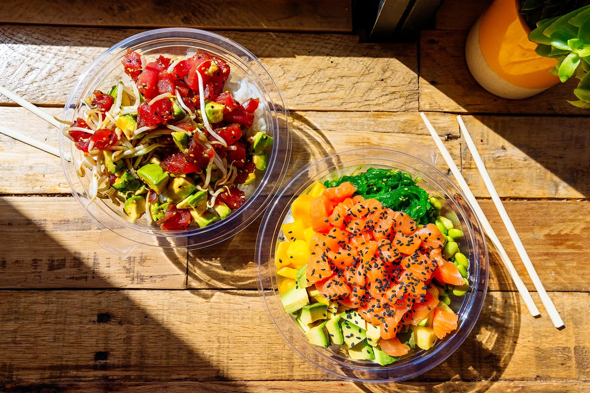 Poke bowls with salmon and tuna on the table