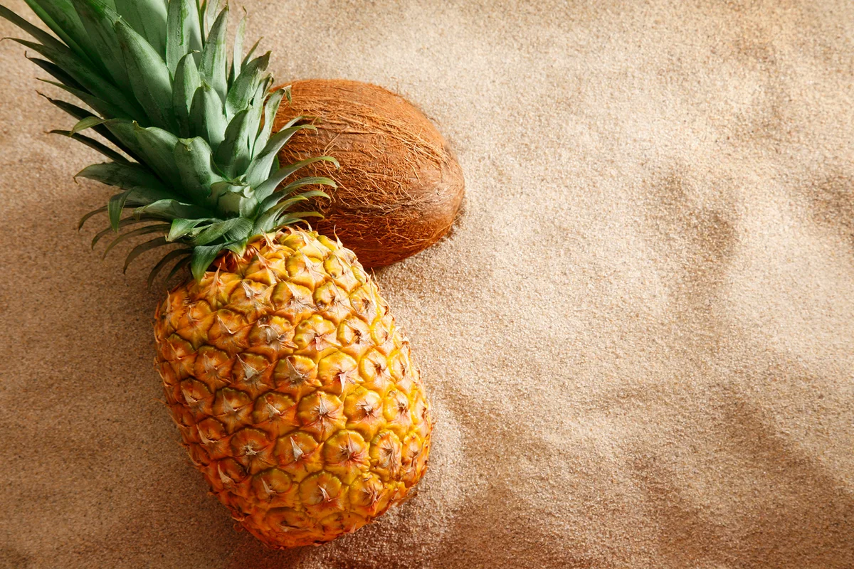 pineapple and coconut on the beach