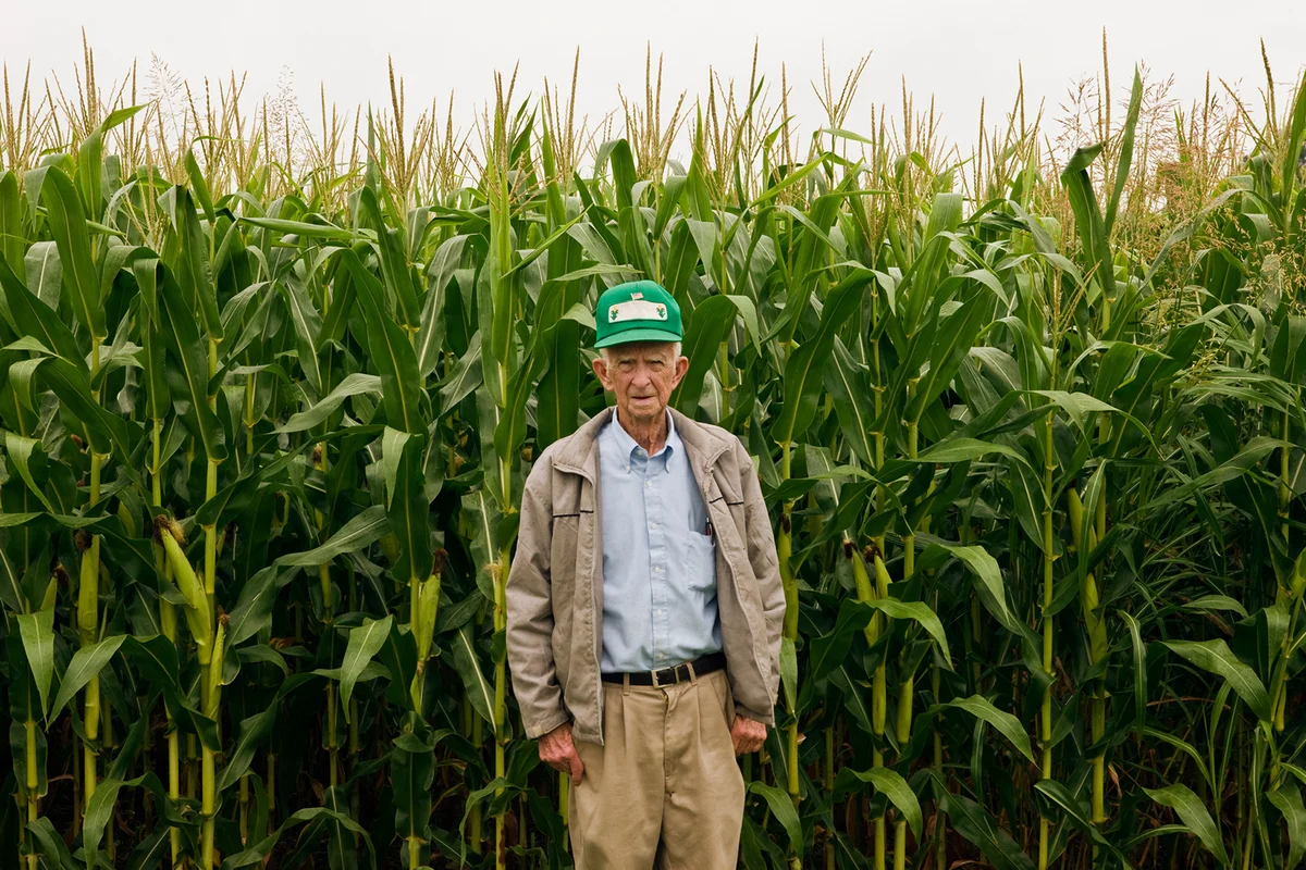Old southern farmer standing in front of his crop