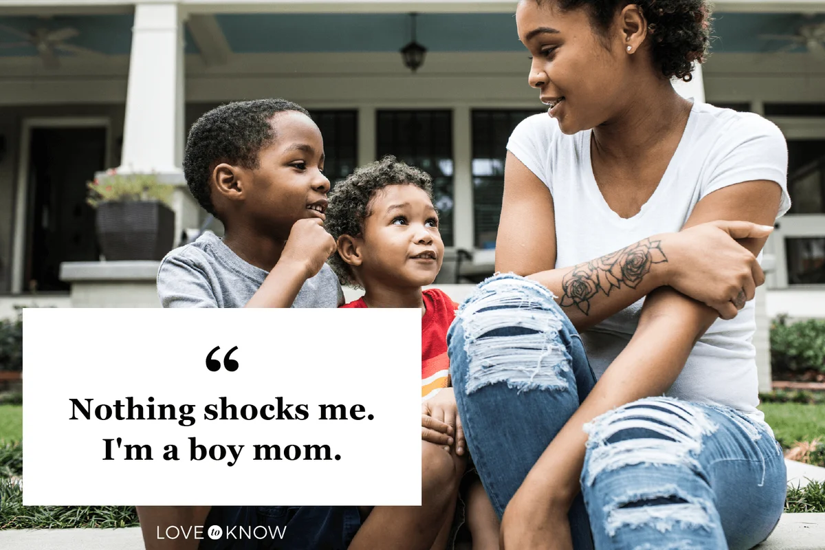 Single mother playing with young sons in front of house