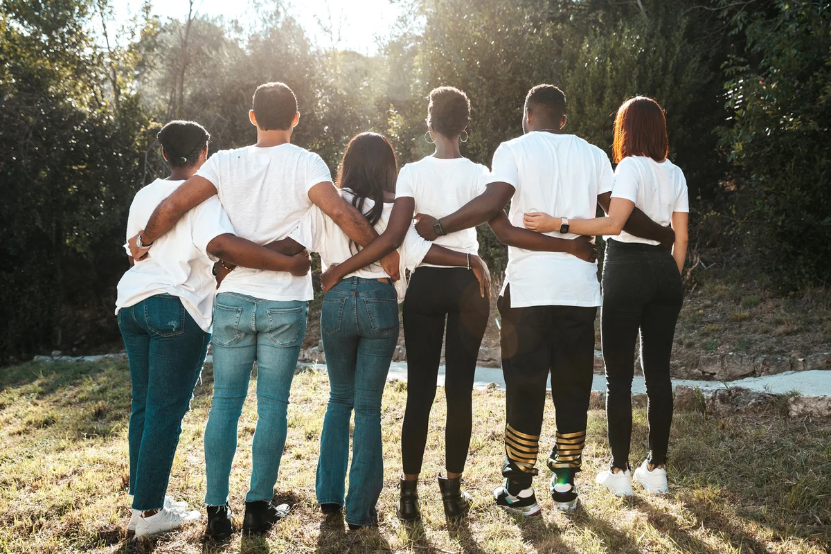 Diverse group of young adults together with white t-shirts