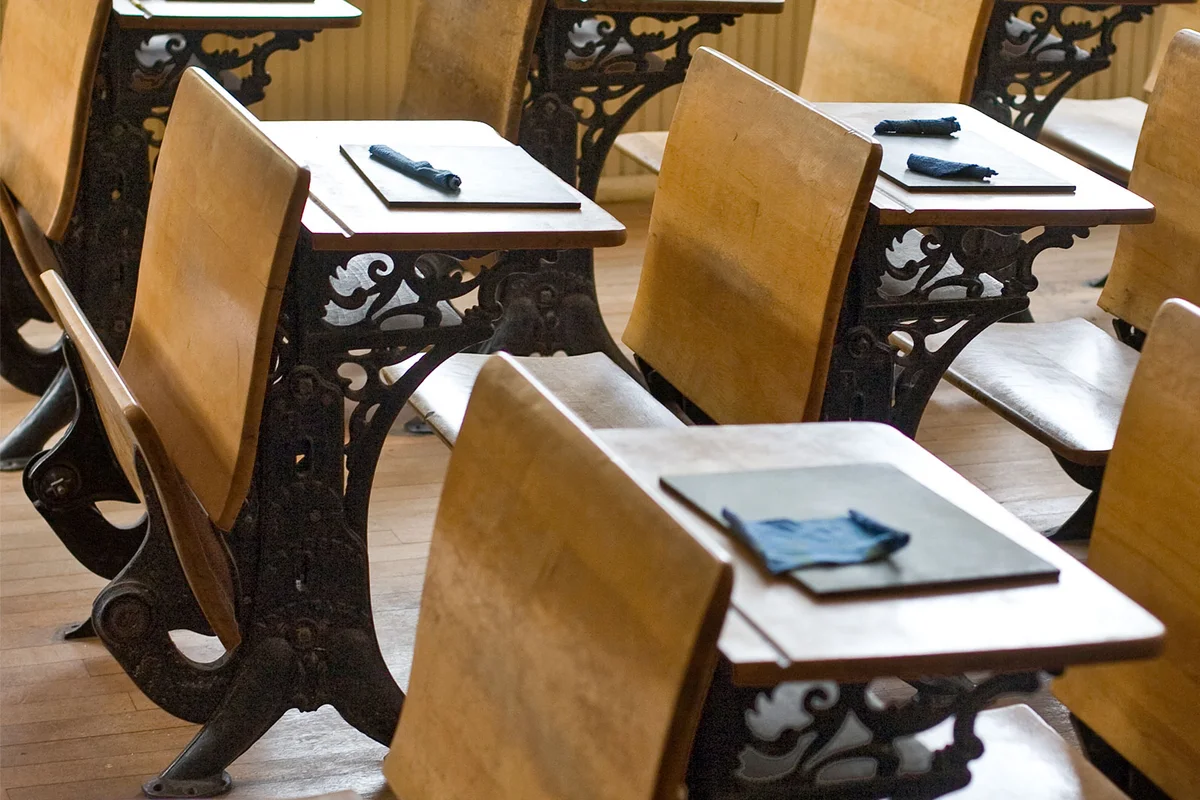 Old classroom with antique chairs and desks