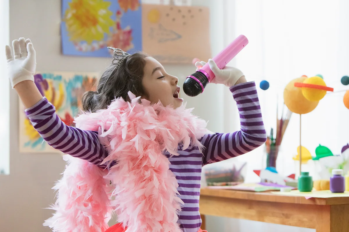 girl dressed as princess singing using a microphone