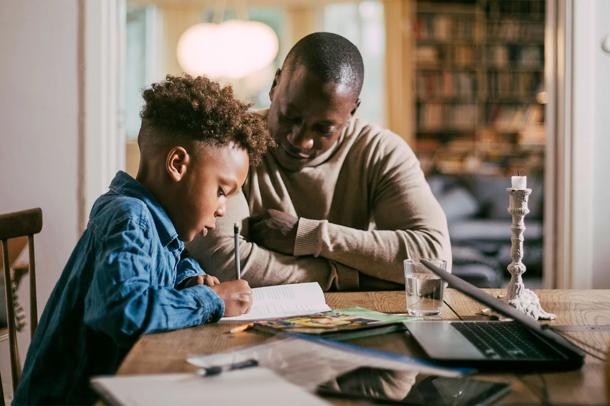 father helping son with homework