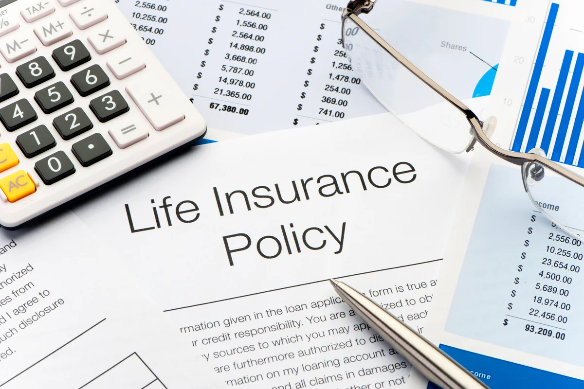 Life Insurance Policy with pen, calculator