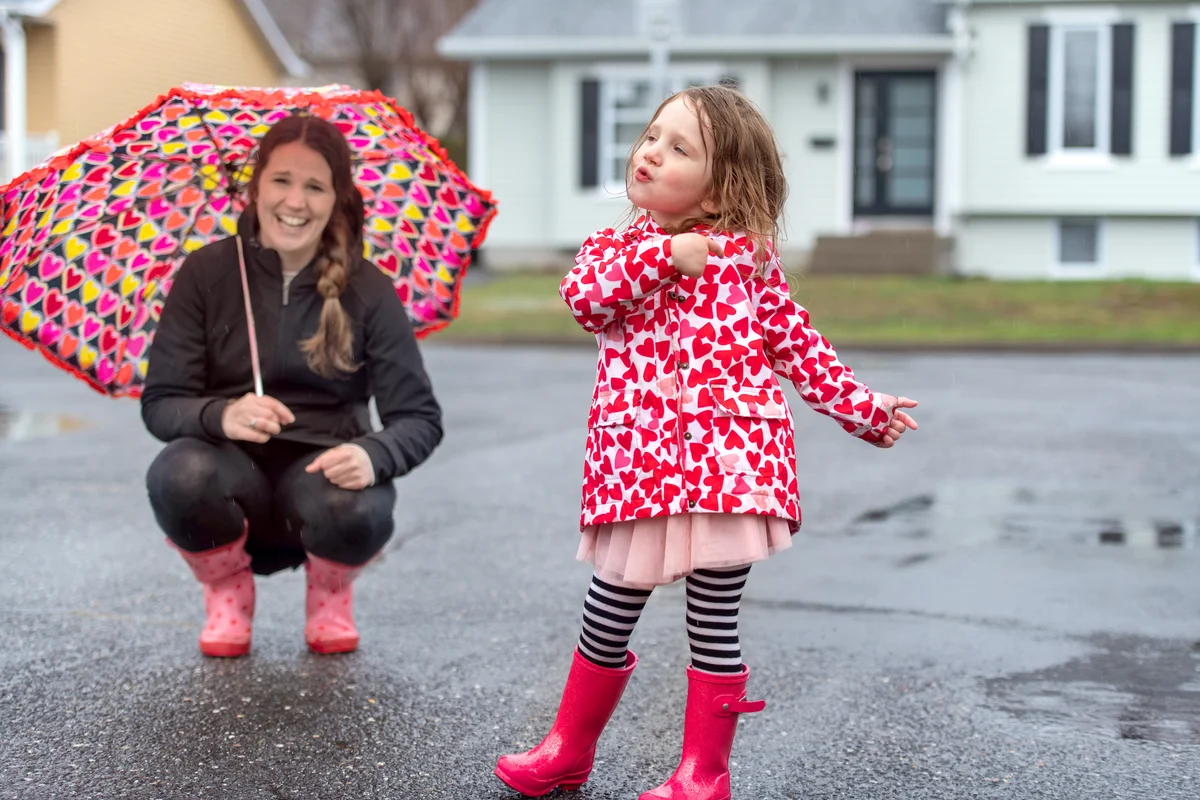 Mother and daughter having fun in the rain