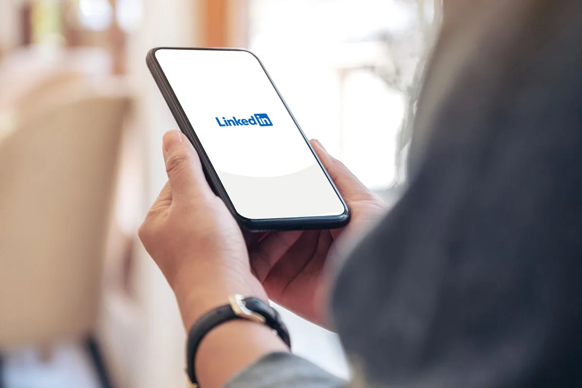 coworker giving LinkedIn recommendation on cell phone