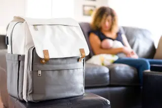 Mom and Newborn Baby in a Home With Diaper Bag