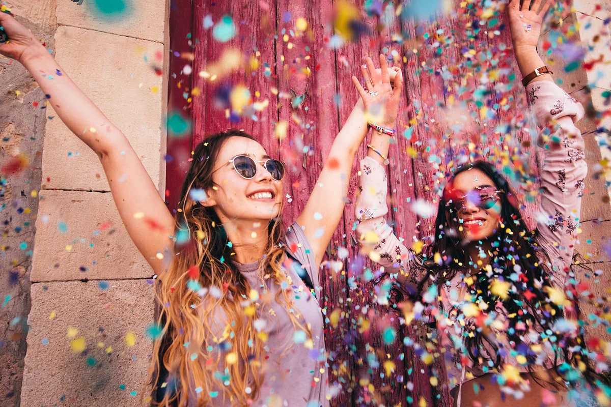 Young hipster women celebrating with confetti 17th birthday