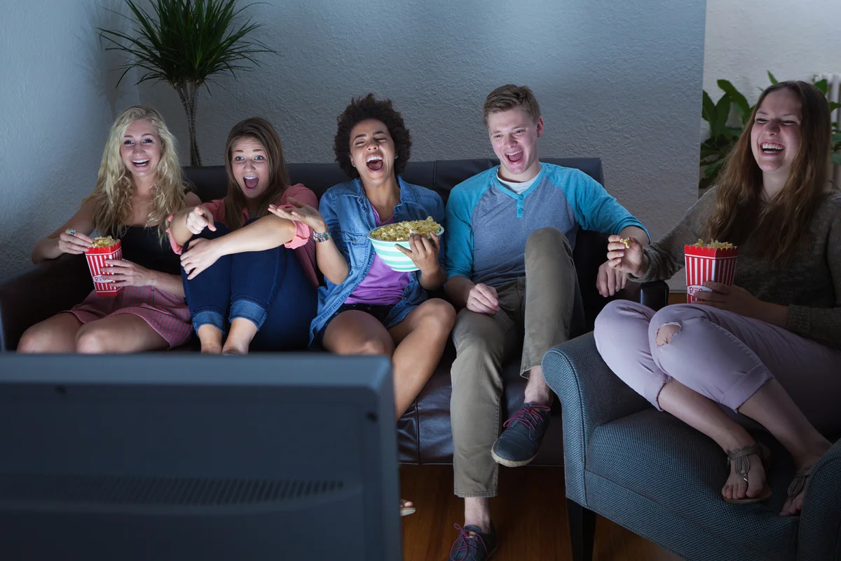 Group of Friends Watching Humorous Movie