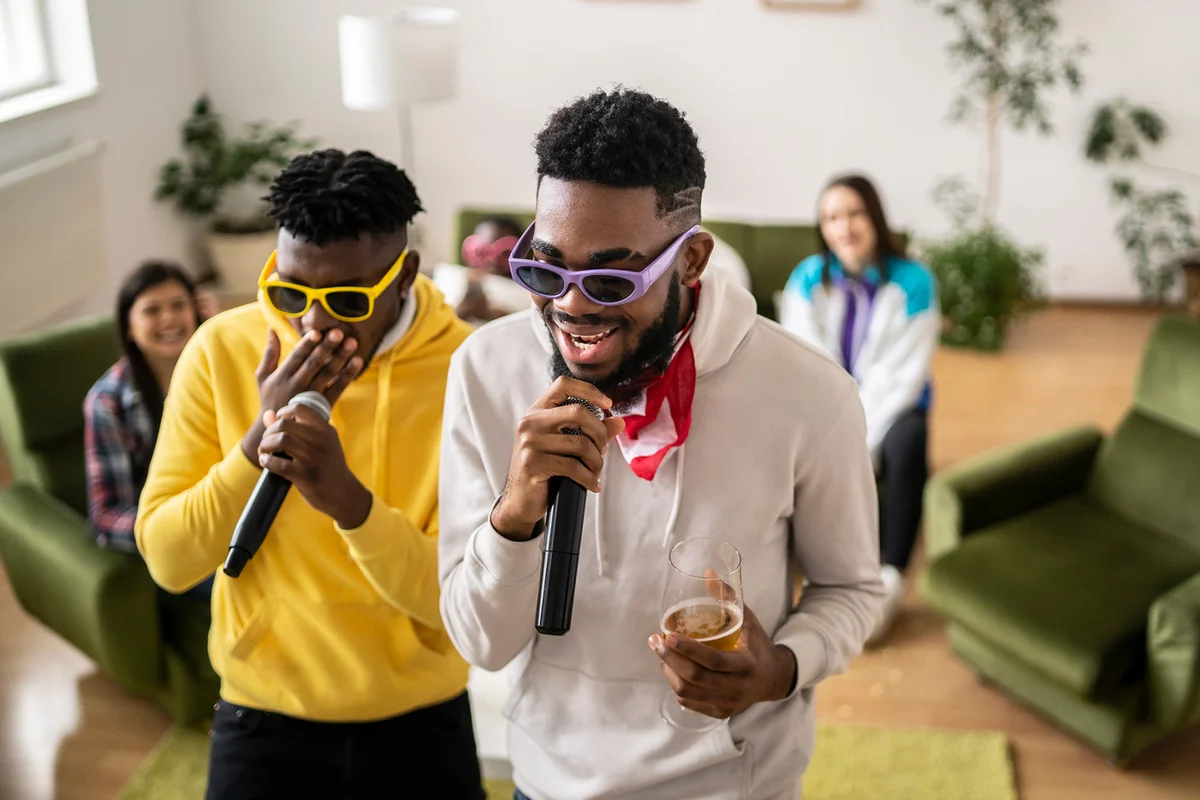 Two friends holding microphones in a karaoke party