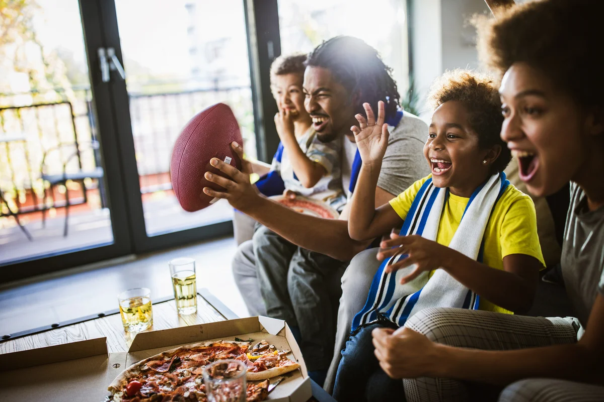 Family cheering while watching a football match