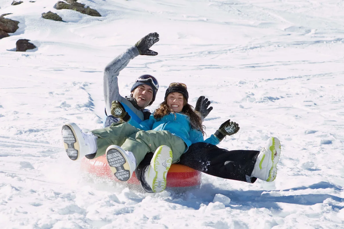 couple snow tubing for birthday celebration