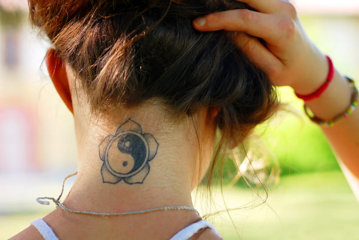 woman with a new tattoo on back of neck