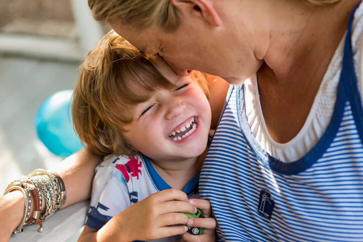 mother and giggling laughing toddler son