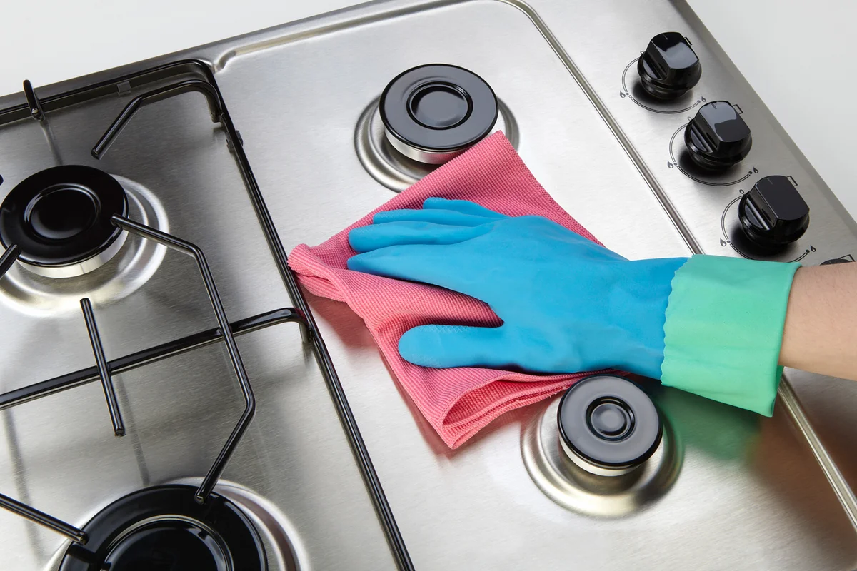 Woman cleaning set-top stove