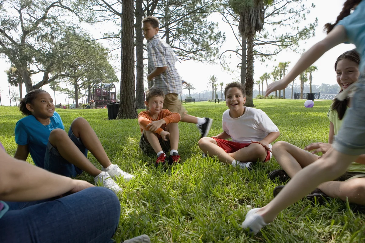 children playing duck duck goose game