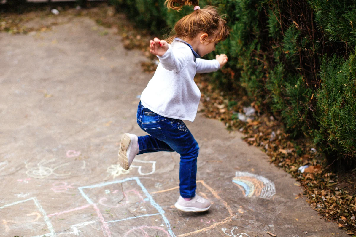 girl playing hopscotch