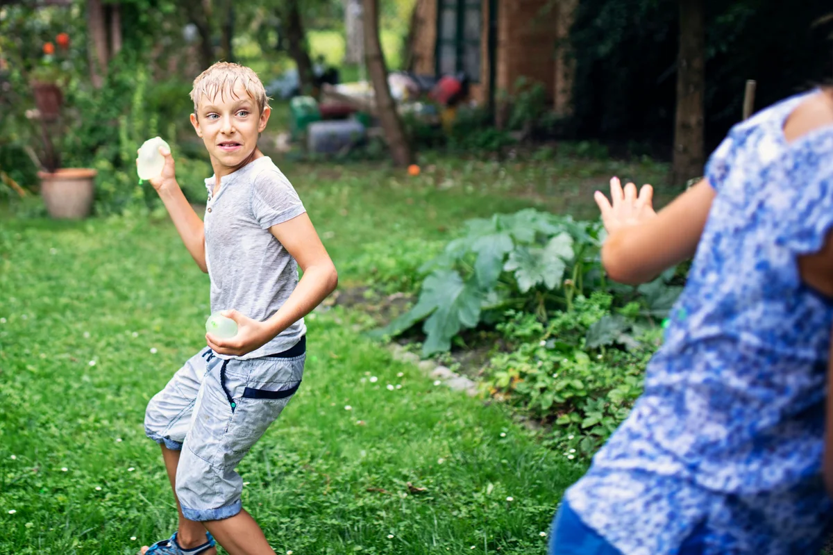 boy throwing water balloon