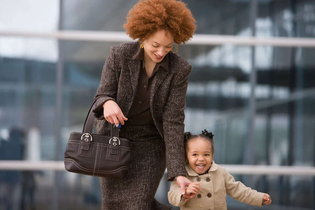working mom holding daughter's hand