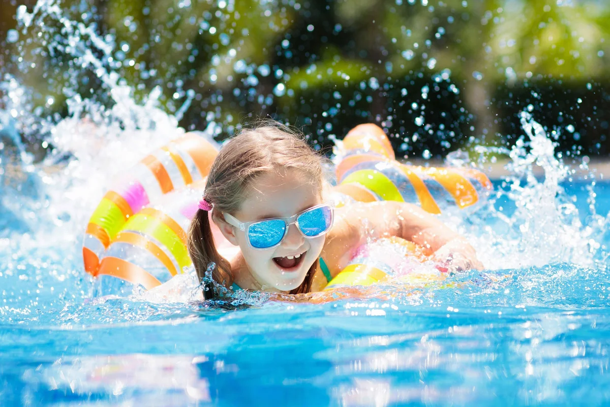 girl swimming fast with pool float