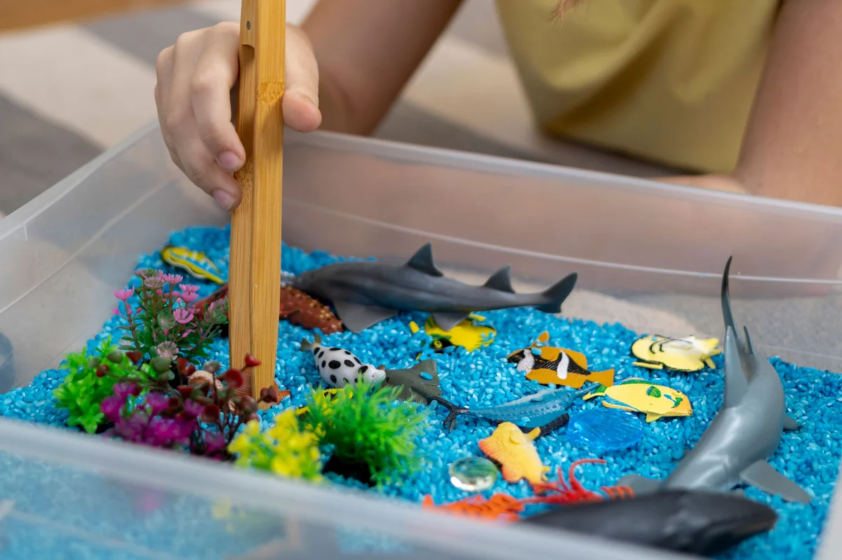 ocean theme sensory bin with tweezers
