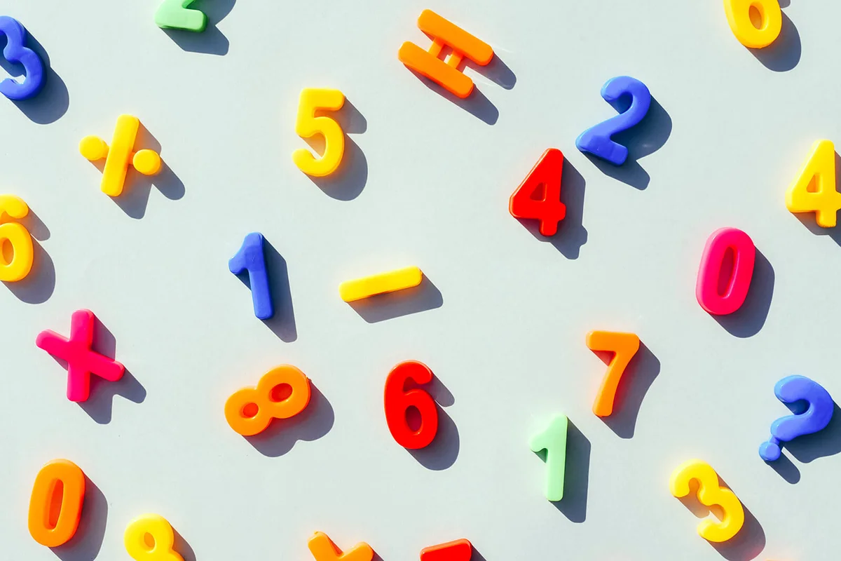 Numbers and mathematical signs on a light blue background