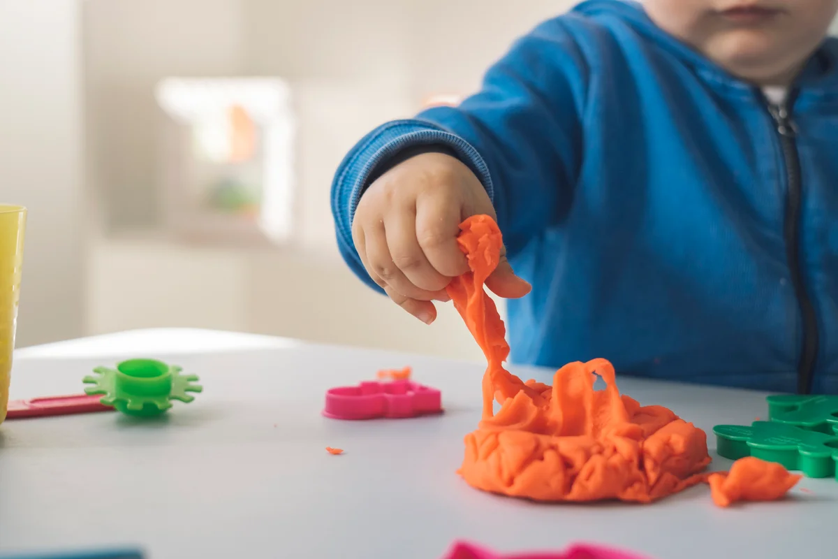 one year old playing with playdough