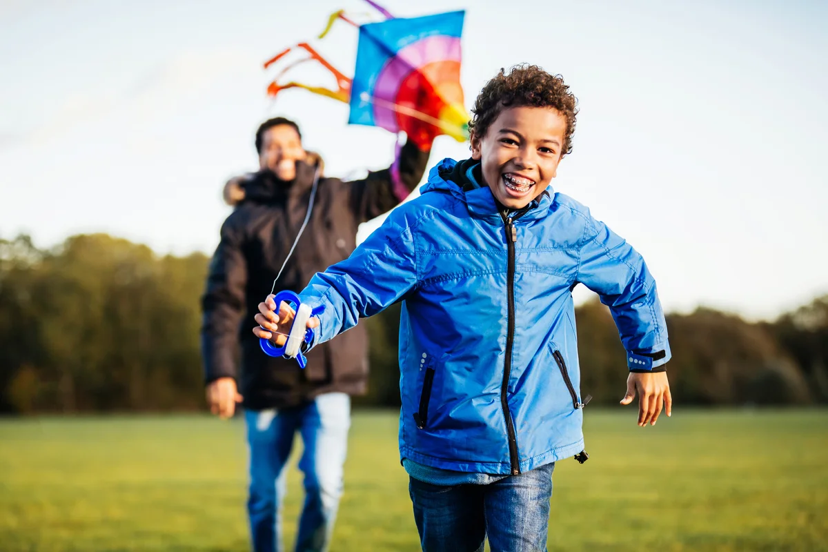 father and son flying kite