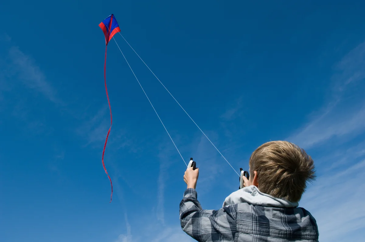 boy flying stunt kite