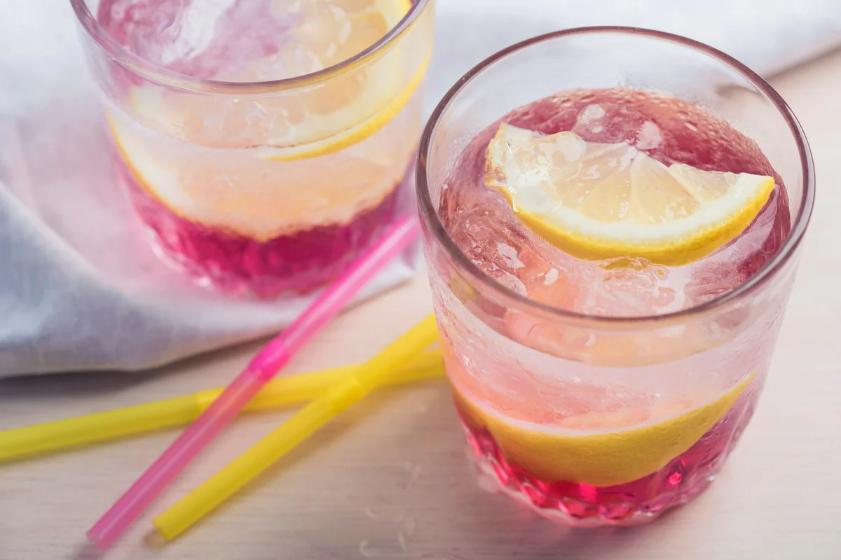 Pink lemonade with ice cubes and Meyer lemons
