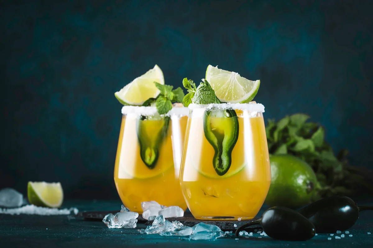 Spicy margarita cocktail with tequila, mango juice, jalapeno pepper, lime and salt