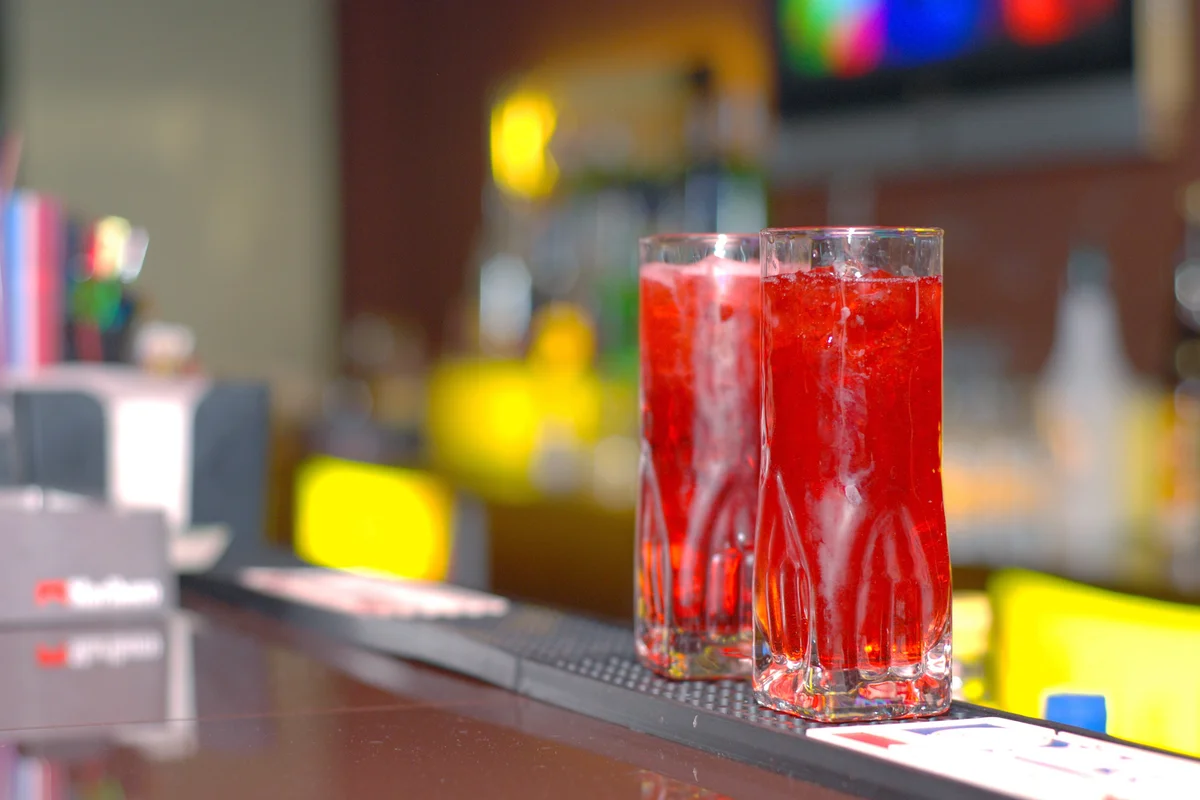 Two red drinks on the counter